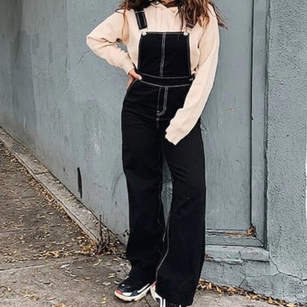 Black overalls with adjustable straps and pockets